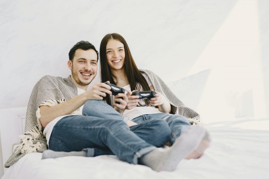 happy couple playing game console while lying on bed 4148889 1024x682 - Breathe your way through tough times